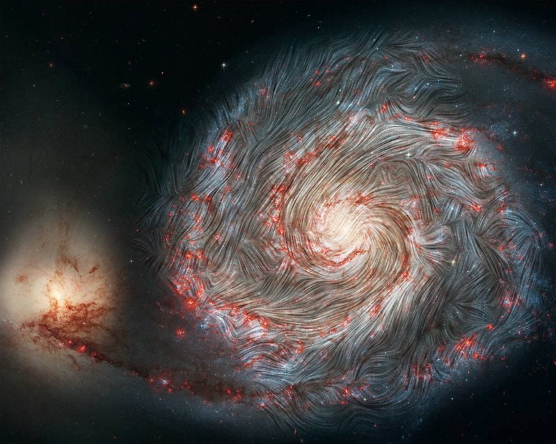 The magnetic field in the Whirlpool Galaxy (M51), measured by the NASA SOFIA infrared observatory, superimposed on a Hubble telescope picture of the galaxy.&nbsp;This image illustrates characteristic magnetic fields of galaxies that can modify neutrino helicities. (Credit: NASA)