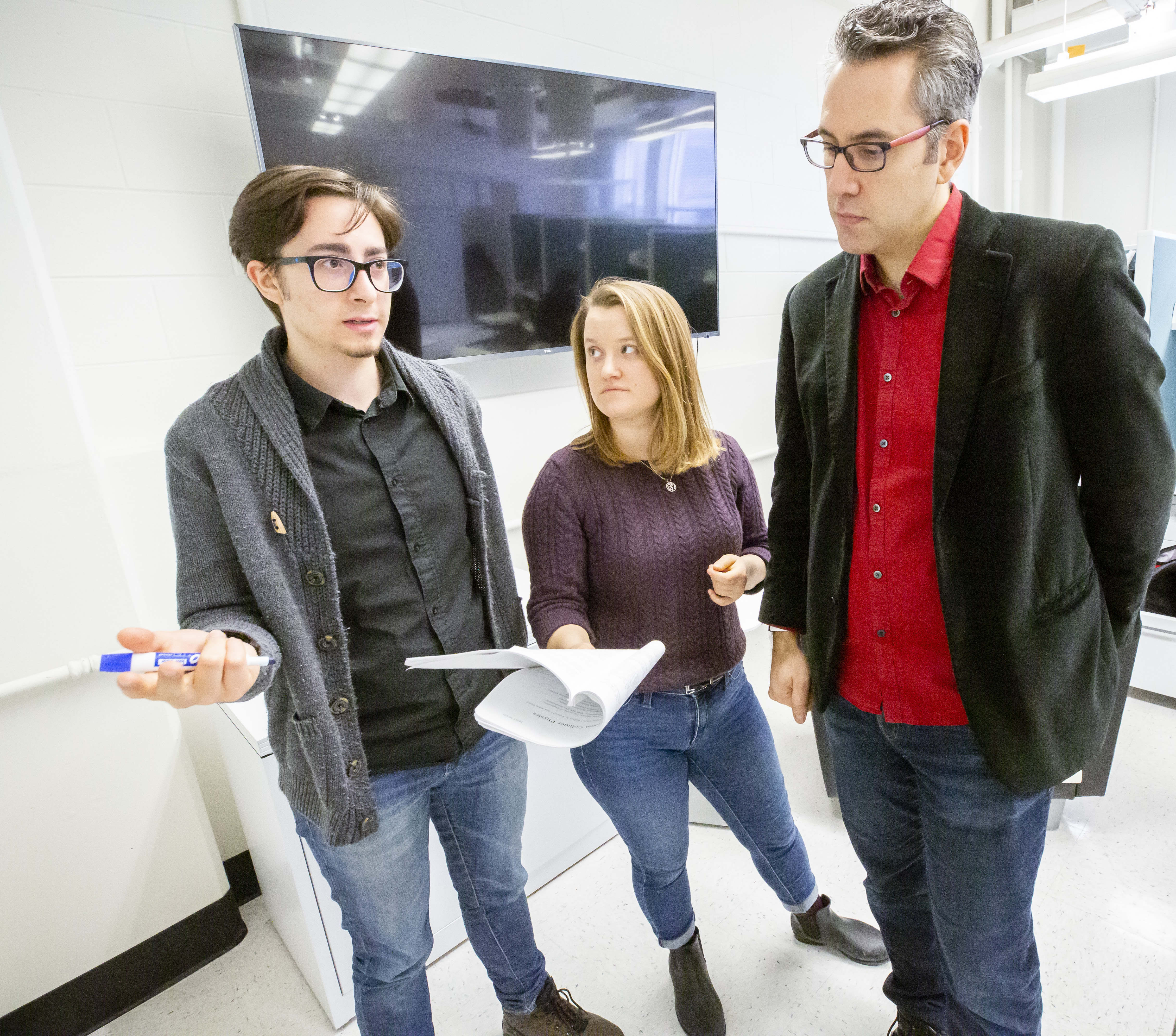 Yunes with graduate students Simone Mezzasoma and Caroline Owen