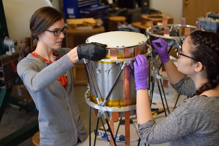 Graduate student Elle Shaw (left) and Illinois Physics alumna&nbsp;Kaliro&euml; Pappas assemble a telescope for SPIDER similar to those that will be developed for Taurus.